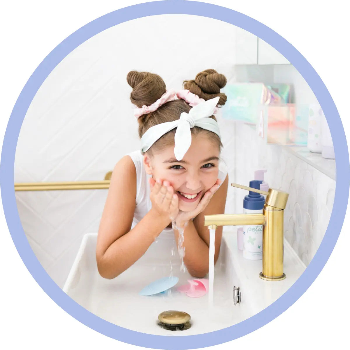 Girl washing face splashing water over basin wearing pyjamas