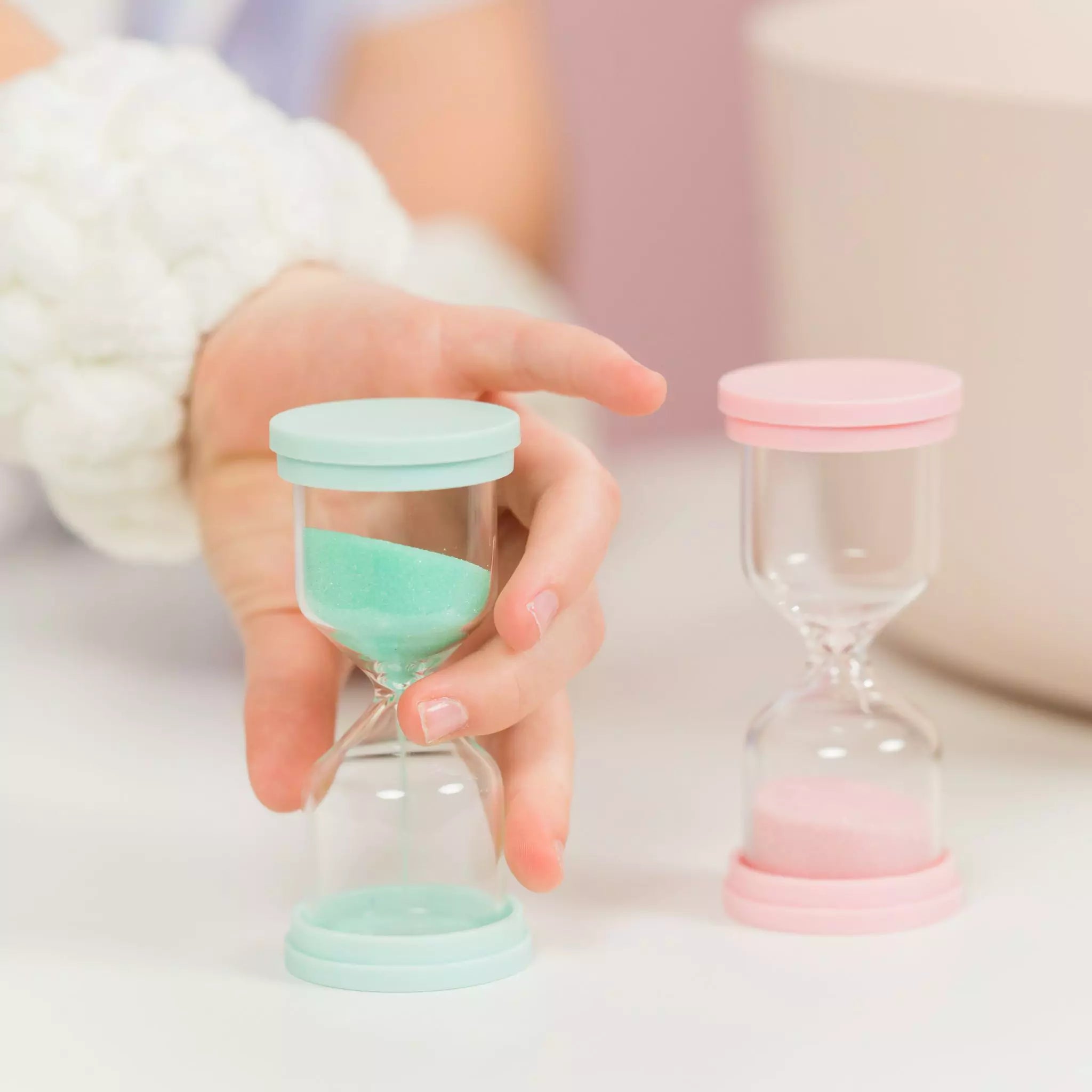 pre-teen girl turning over Petite Skin Co. 60 second skincare timer before doing skin routine