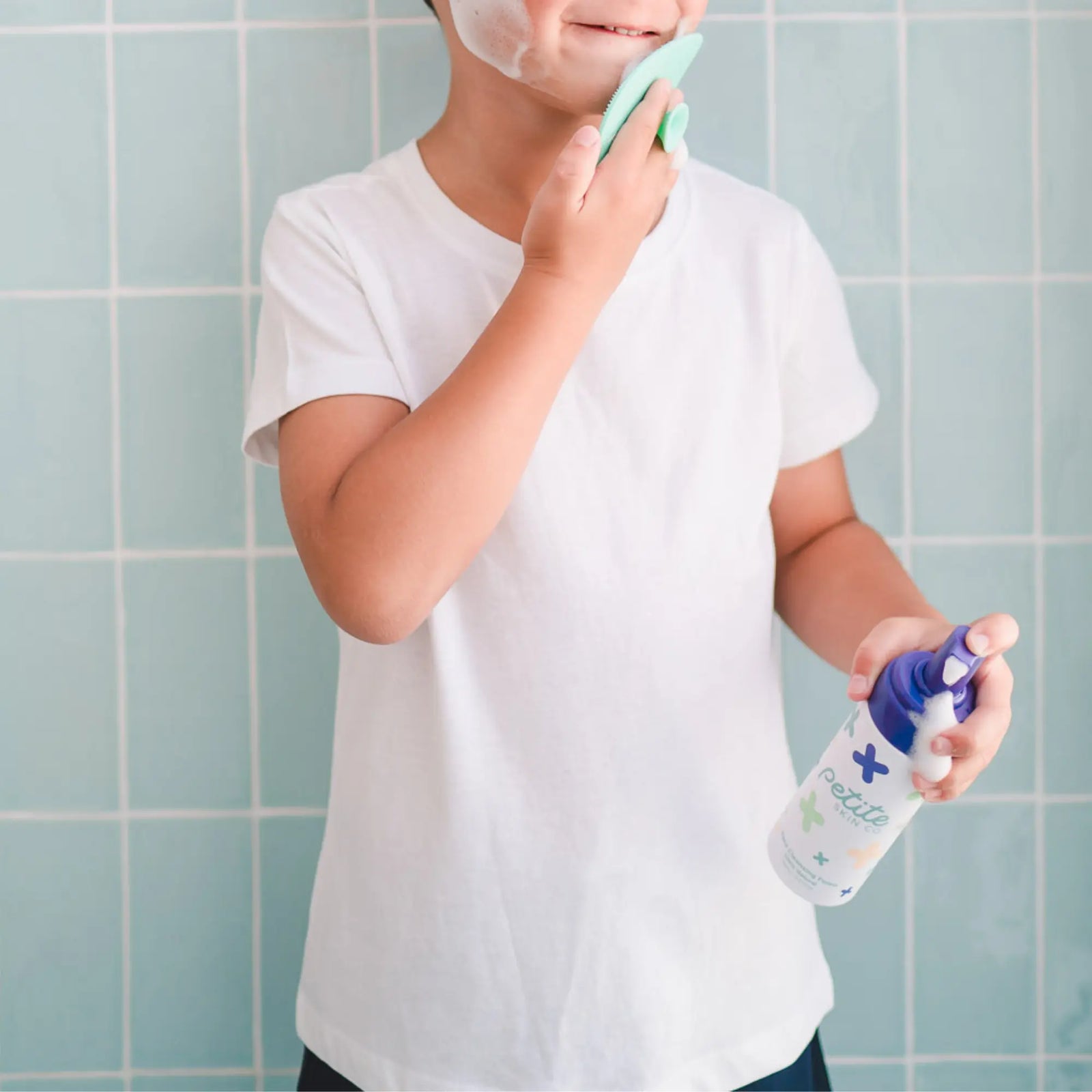 Child using Teardrop Shape Skin Buffers with face cleansing foam in bathroom, demonstrating gentle Australian made skincare for 7 to 14 year olds, promoting good skin habits.