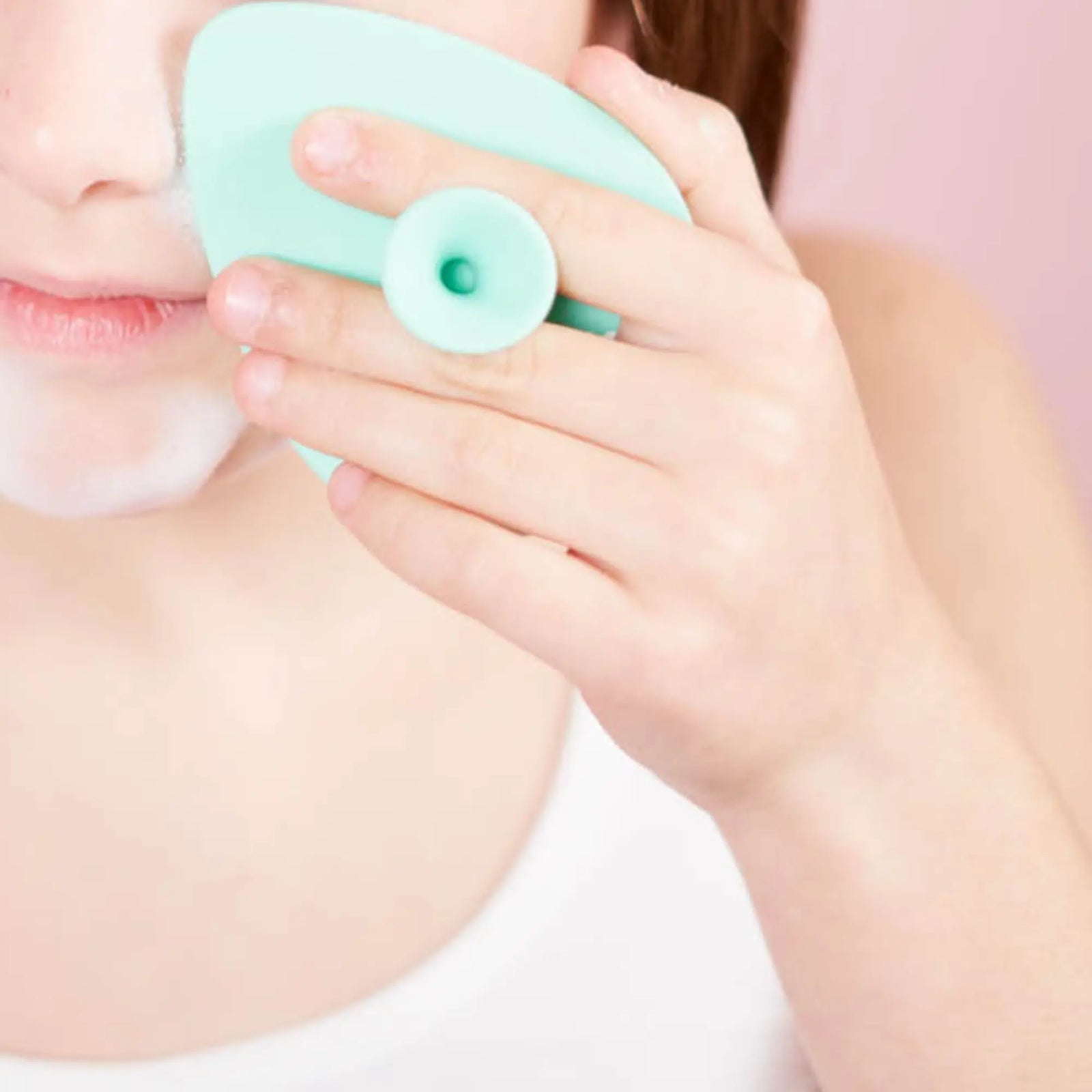 Child using a teal Teardrop Shape Skin Buffers made from soft food-grade silicone to gently cleanse developing skin, promoting good skin habits early with Australian made care.