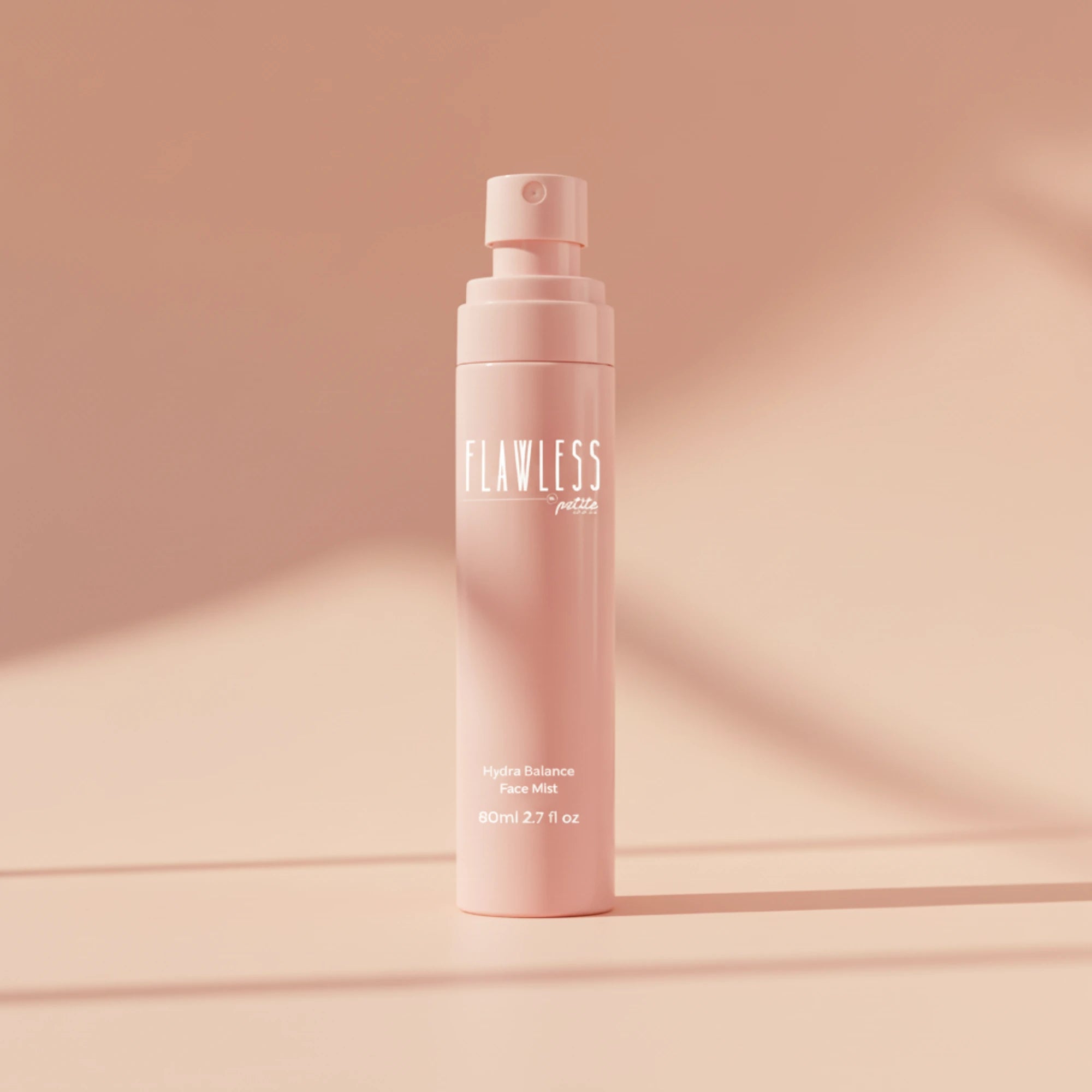 Pink 'FLAWLESS' face mist bottle on a matching pink background