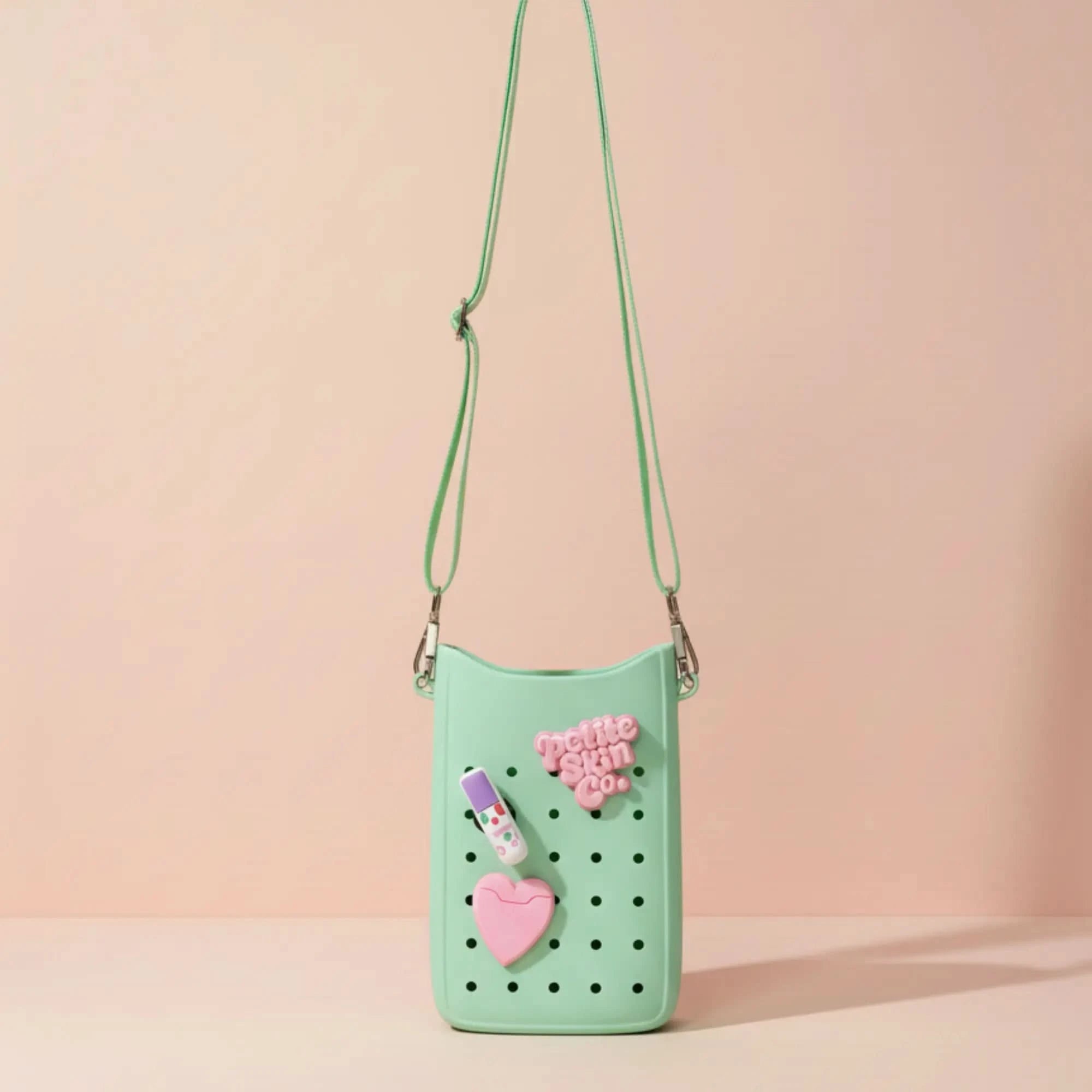 Petite Crossbody Bag in pastel green with pink charm accessories, Australian made, natural design for 7 to 14 year olds, inspired by gentle skincare routines. Good Skin Habits Start Early.
