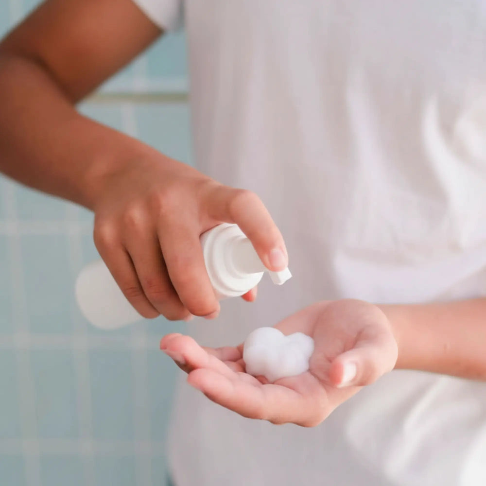 Child dispensing foamy face cleansing foam into palm, illustrating Daily Duo Kit | Crosses Collection Australian made gentle skincare routine for 7 to 14 year olds from Petite Skin Co. Good Skin Habits Start Early.