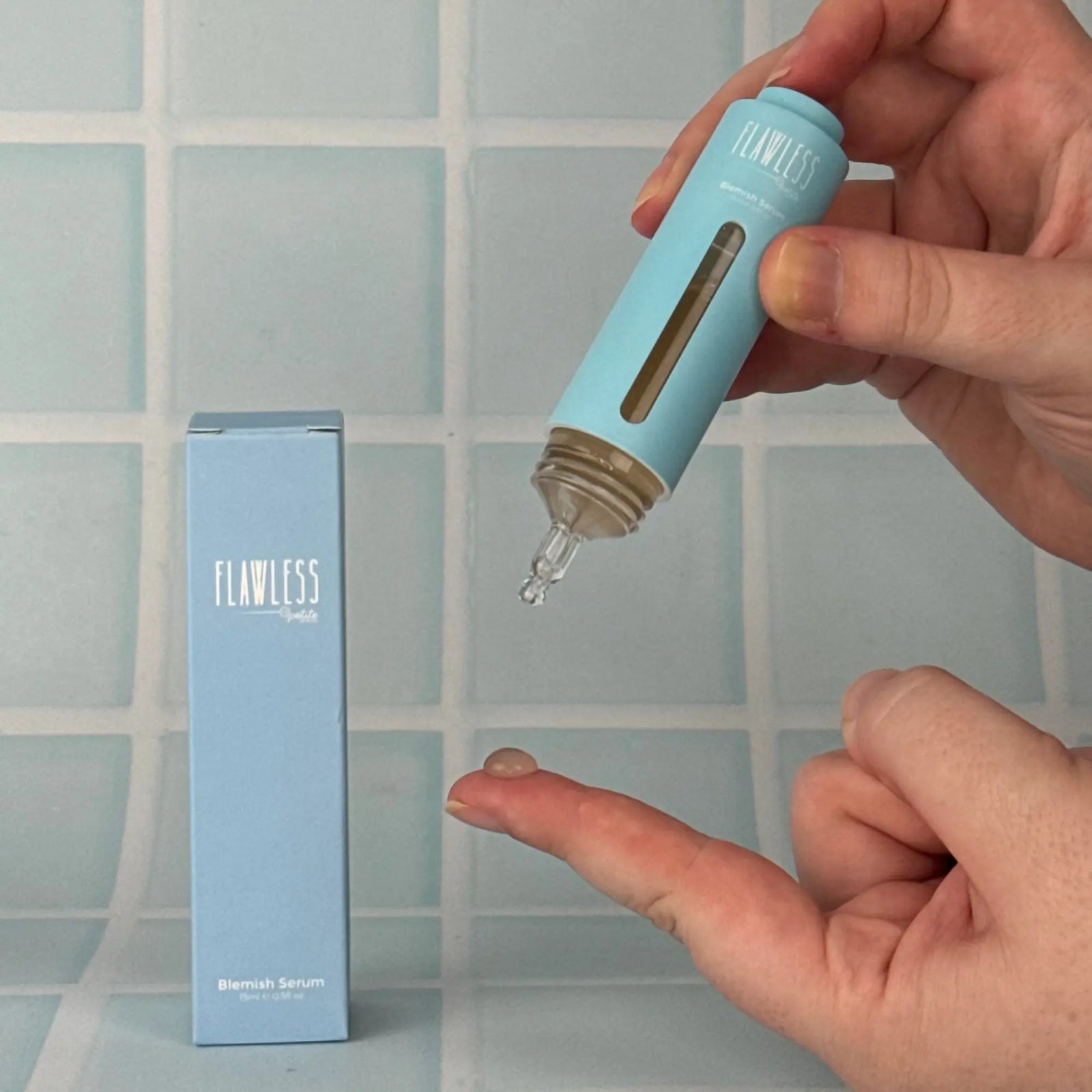 Person dispensing clear Blemish Serum from a blue bottle onto fingertip, next to matching light blue packaging, Australian made natural skincare for 7 to 14 year olds, good skin habits start early.
