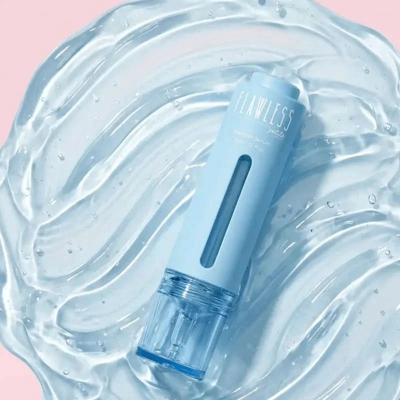 Blue skincare product labeled 'FLAWLESS' on a textured blue surface with a pink background