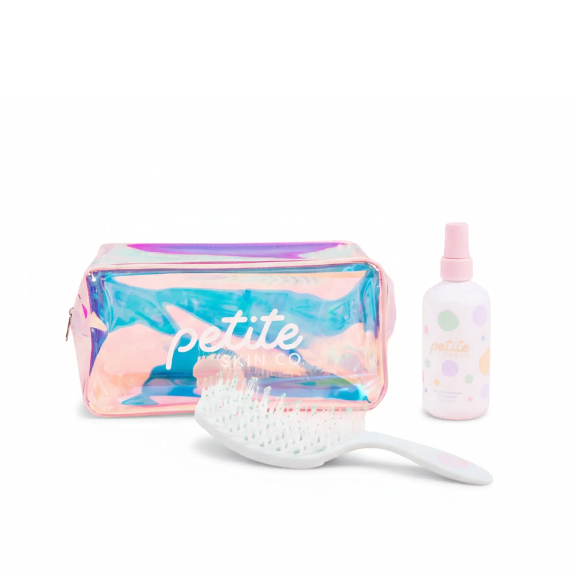 Iridescent pouch with 'petite' text, white brush, and pink bottle on a white background