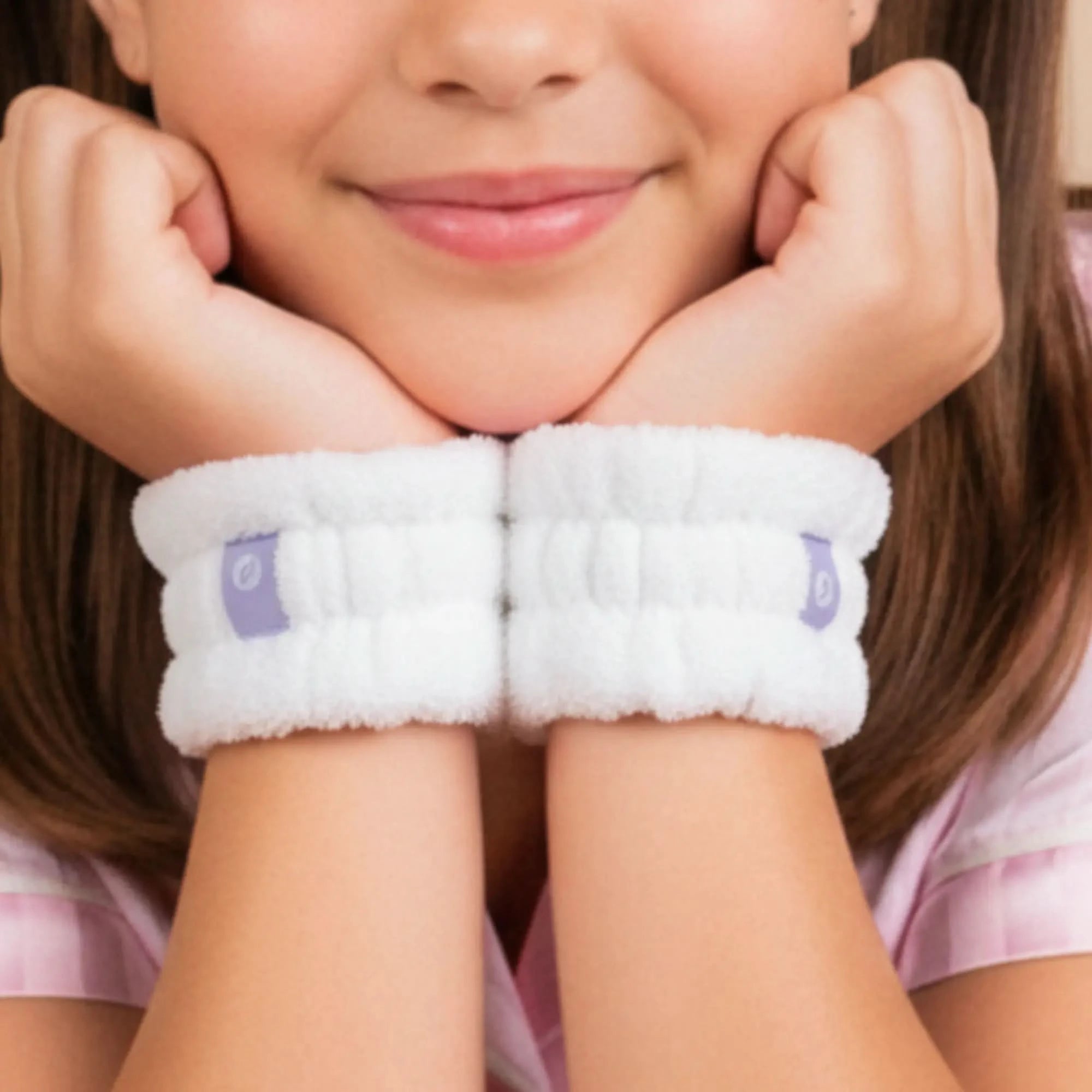 Young girl wearing white Dry Cuffs on wrists, designed to keep sleeves dry during face washing, part of Australian made gentle skincare for 7 to 14 year olds. Good Skin Habits Start Early.