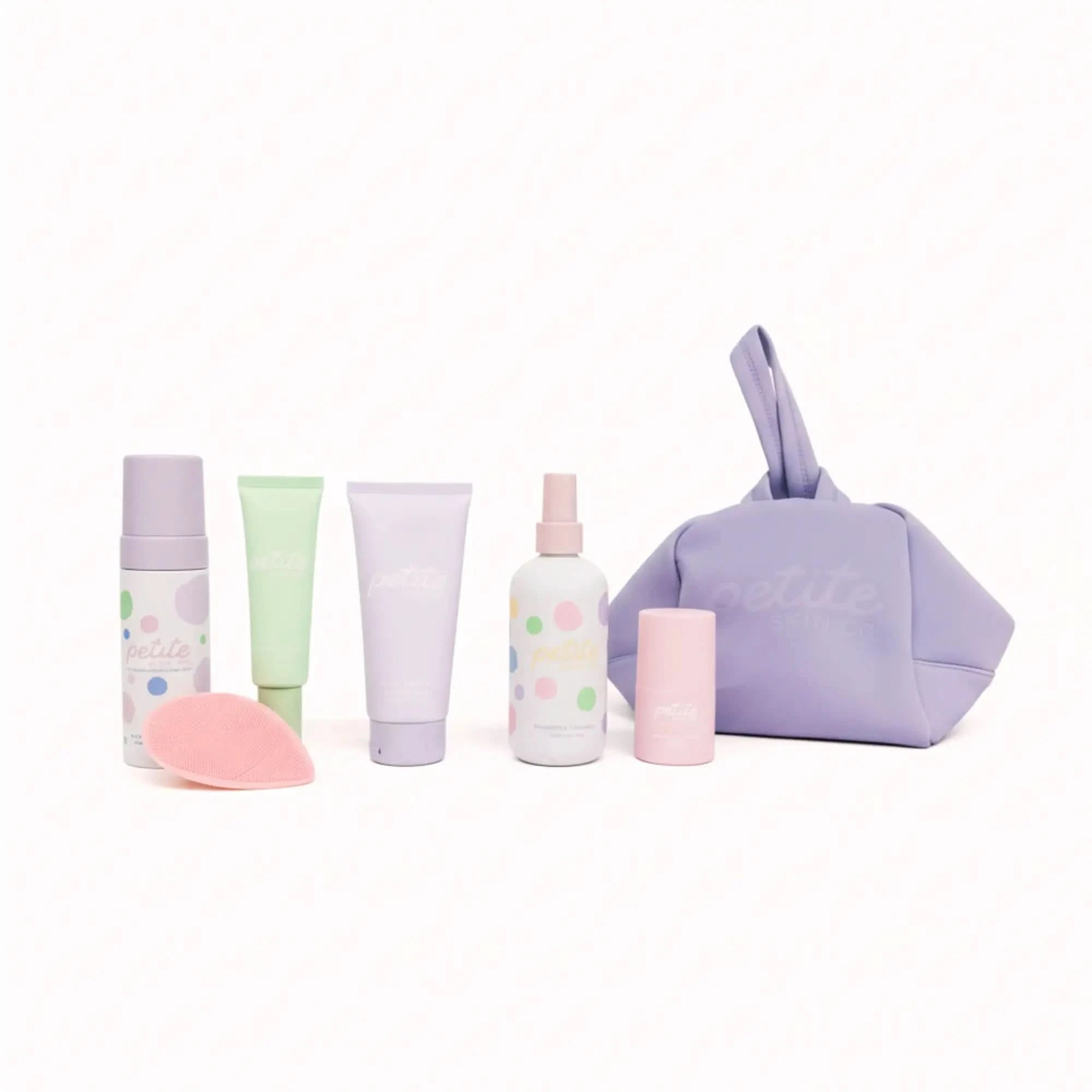 Set of pastel-colored skincare products with a purple pouch on a white background