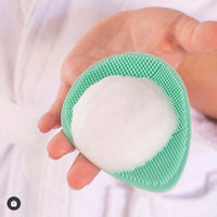 Hand holding a mint green Teardrop Shape Skin Buffers with white foamy face cleansing foam, designed for gentle skincare for 7 to 14 year olds, Australian made, natural, good skin habits start early.