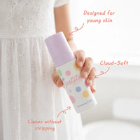Child holding a bottle of Clear Skin Essentials | Confetti Collection face cleansing foam, Australian made gentle skincare for 7 to 14 year olds promoting good skin habits start early