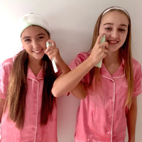 Two girls in pink pajamas demonstrate the Night Time Routine | Confetti Collection using gentle skincare tools, promoting Australian made, natural products designed for 7 to 14 year old skin. Good Skin Habits Start Early.