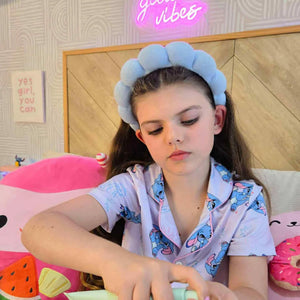 Young girl wearing a blue headband and pajamas applying skincare, promoting Daily Duo Kit | Confetti Collection, Australian made, natural, and designed for 7 to 14 year old skin. Good Skin Habits Start Early.