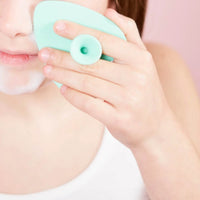 Child using a teal Teardrop Shape Skin Buffers made from soft food-grade silicone to gently cleanse developing skin, promoting good skin habits early with Australian made care.