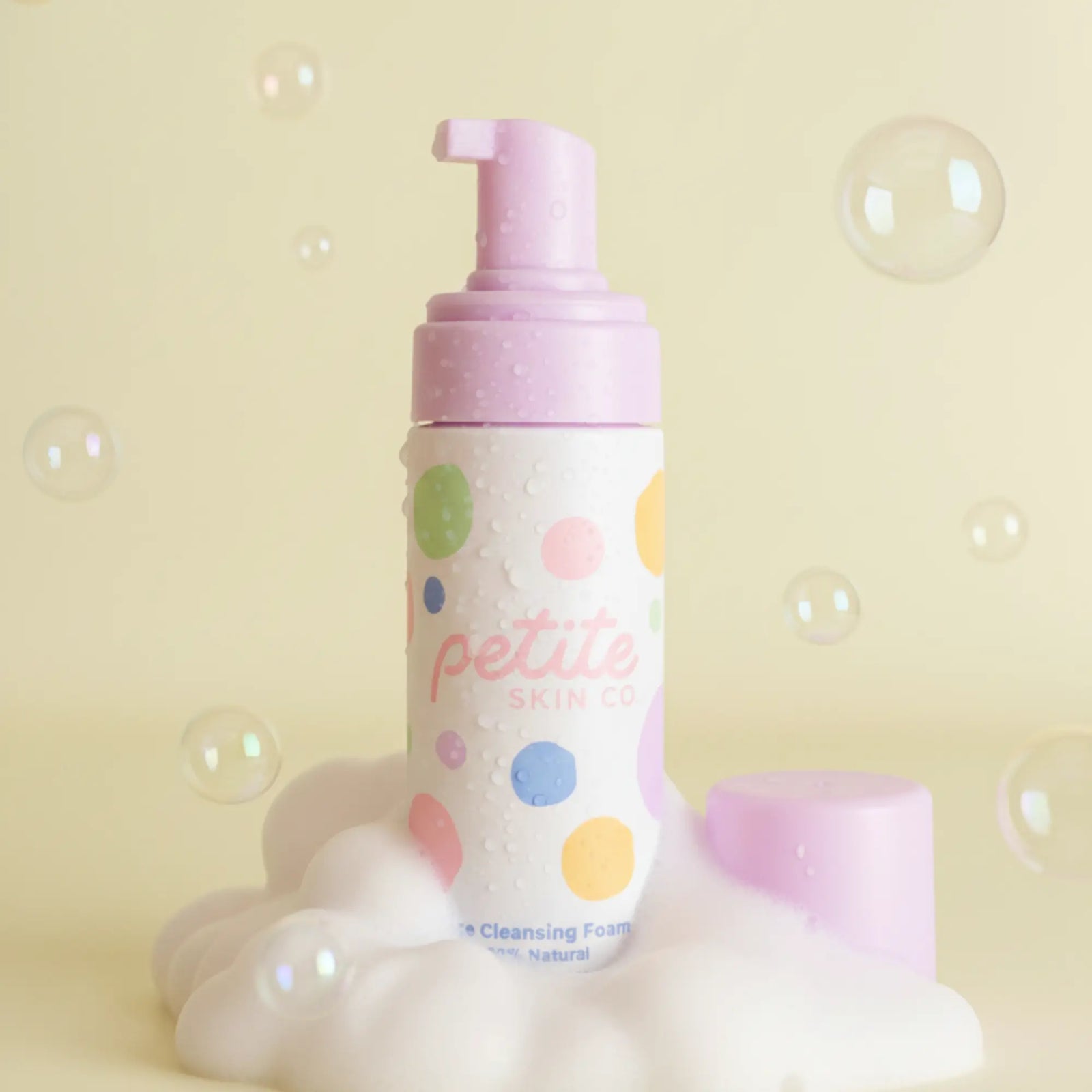 The Sleepover Essentials Kit featuring a gentle face cleansing foam in a colorful polka dot bottle with a pink pump, surrounded by foam and bubbles, Australian made, natural, made for the biology of 7 to 14 year old skin. Good Skin Habits Start Early.