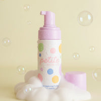 The Sleepover Essentials Kit featuring a gentle face cleansing foam in a colorful polka dot bottle with a pink pump, surrounded by foam and bubbles, Australian made, natural, made for the biology of 7 to 14 year old skin. Good Skin Habits Start Early.