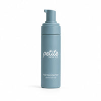 A light blue cylindrical pump bottle of Petite Skin Co Face Cleansing Foam, shown on a clean white background.