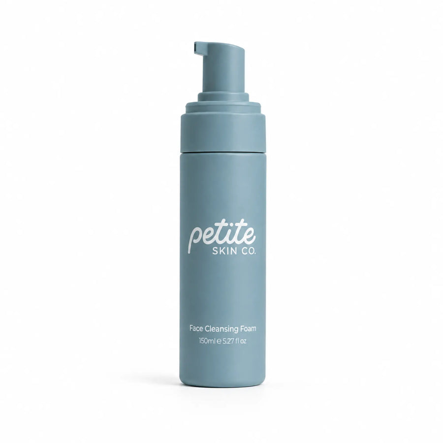 A light blue cylindrical pump bottle of Petite Skin Co Face Cleansing Foam, shown on a clean white background.