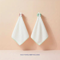 Two mint and pink Daily Essentials Hook with strong adhesive backing holding white face towels on a peach wall, Australian made, natural, designed for 7 to 14 year old skin. Good Skin Habits Start Early.