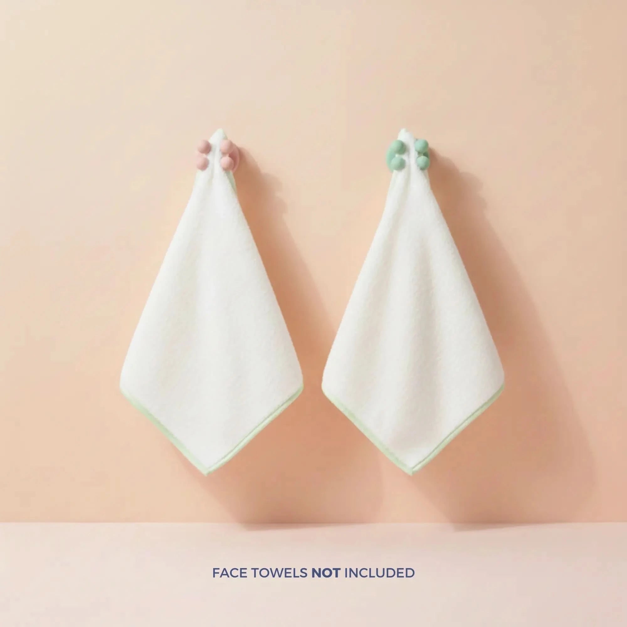 Two mint and pink Daily Essentials Hook with strong adhesive backing holding white face towels on a peach wall, Australian made, natural, designed for 7 to 14 year old skin. Good Skin Habits Start Early.