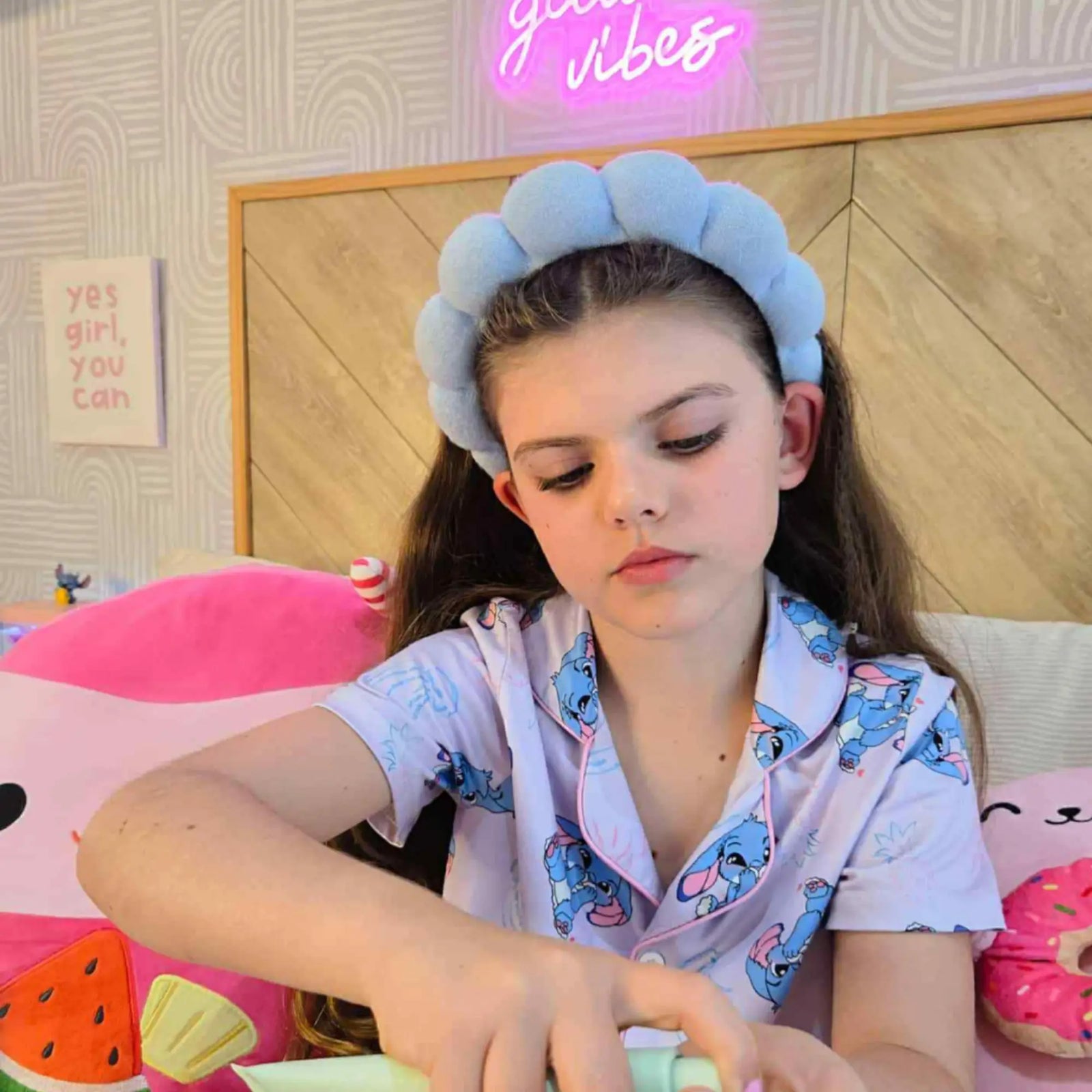 Young girl wearing a blue headband and a playful pajama top using Clear Skin Essentials | Confetti Collection skincare, featuring Australian made natural products for 7 to 14 year olds. Good Skin Habits Start Early.