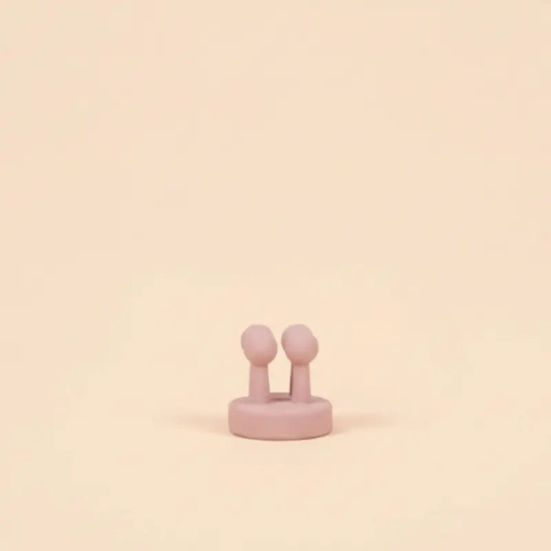 Pink storage hook holder on a beige background