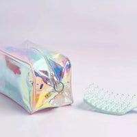 Detangling Brush with dual-bristle design and rubberised handle beside a holographic iridescent travel bag, Australian made for gentle tween hair care ages 7 to 14. Good Skin Habits Start Early.