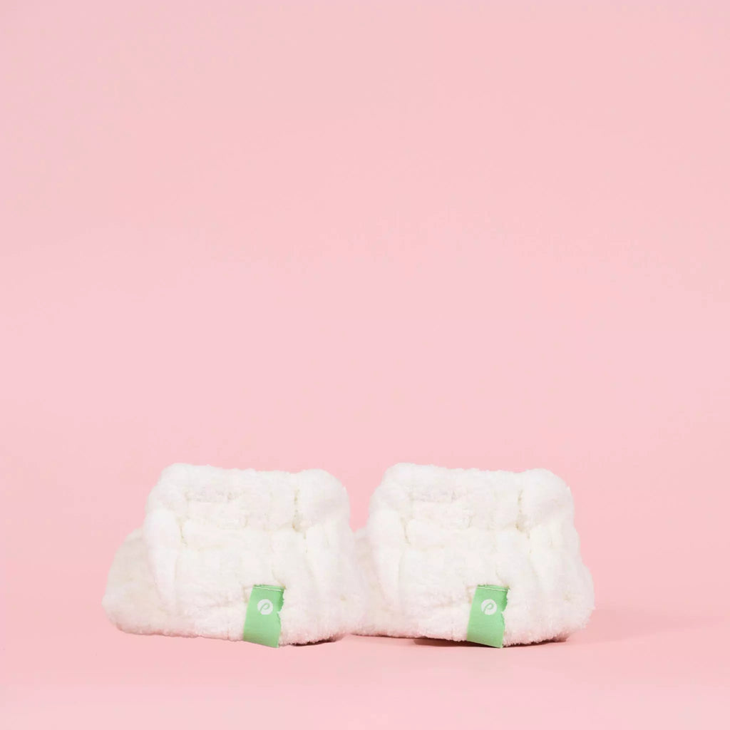 Pair of Petite Skin Co. Dry Cuffs on pink backdrop