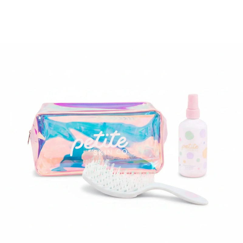 Good Hair Habits Routine featuring an iridescent pink and blue Petite Skin Co. pouch, a white hairbrush, and a spray bottle with pastel polka dots, Australian made natural products for 7 to 14 year olds. Good Skin Habits Start Early.