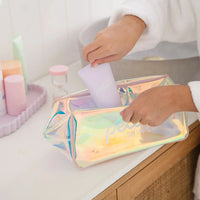 Child placing a skincare product into a holographic bag featuring Petite Skin Co. branding, showcasing The Sleepover Essentials Kit, Australian made for gentle skincare for 7 to 14 year olds with the tagline Good Skin Habits Start Early.