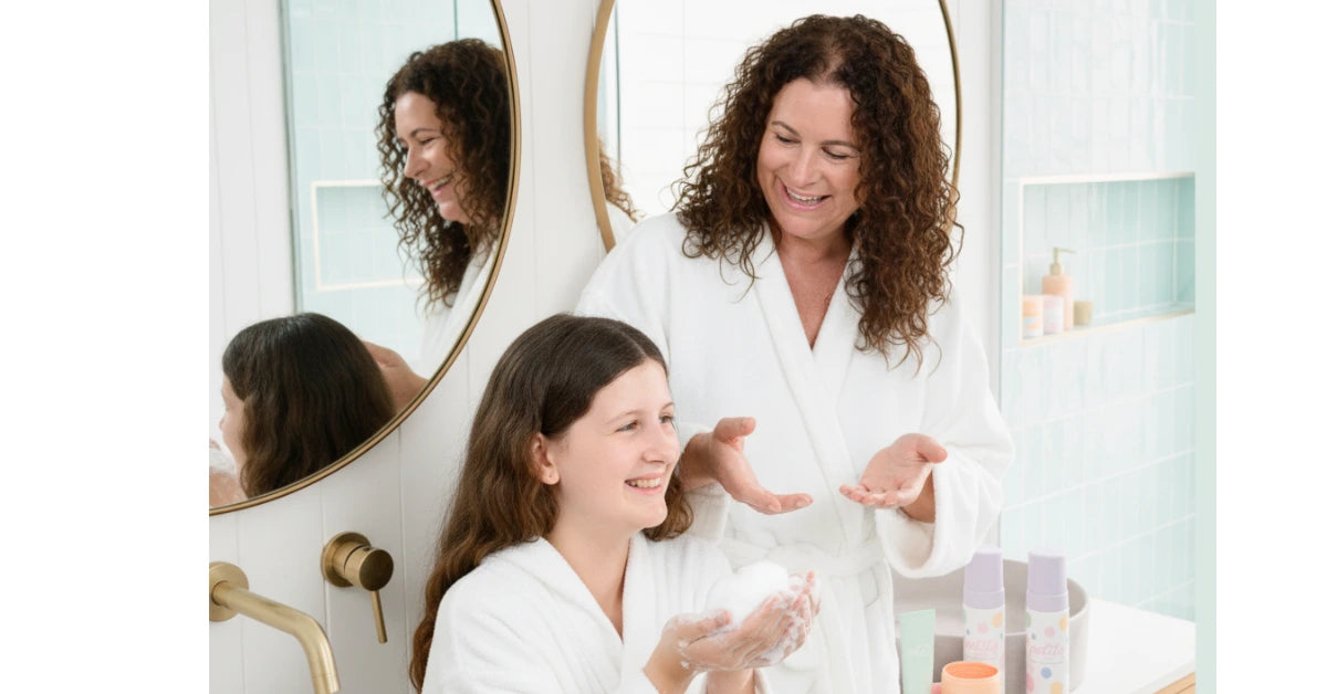 The owner  of petite skin co and her daughter in a bathroom wearing white bath robes
