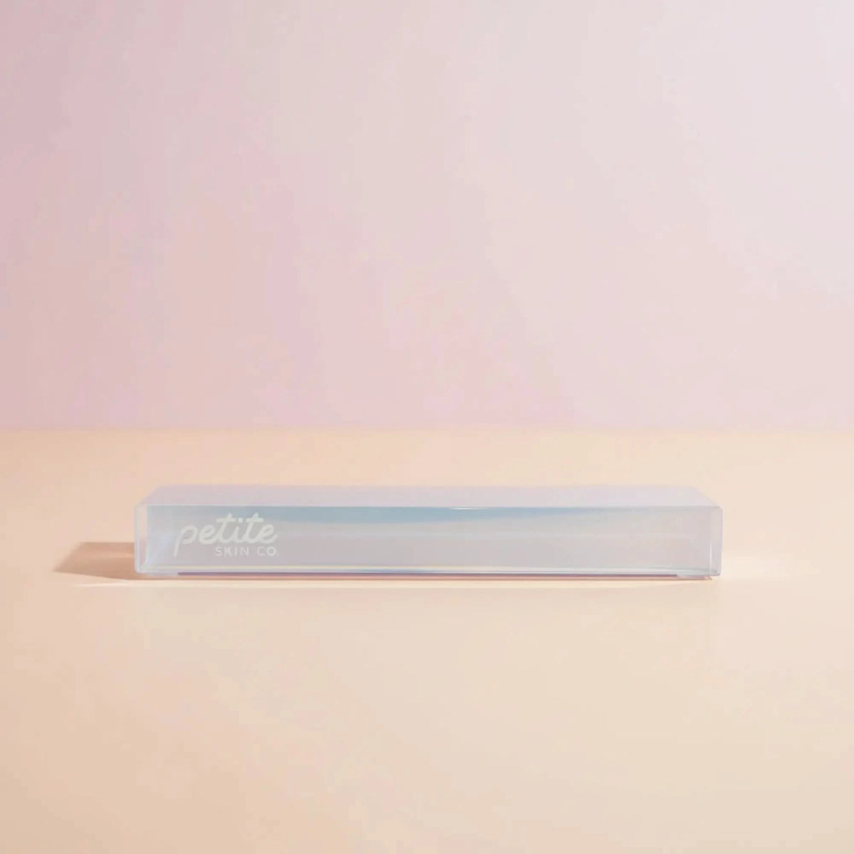 Rectangular white object with 'petite' branding on a gradient background