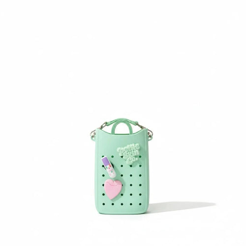 Mint green Petite Crossbody Bag featuring ventilation holes, a lip balm and heart charm, designed with gentle, natural Australian made values for 7 to 14 year olds. Good Skin Habits Start Early.