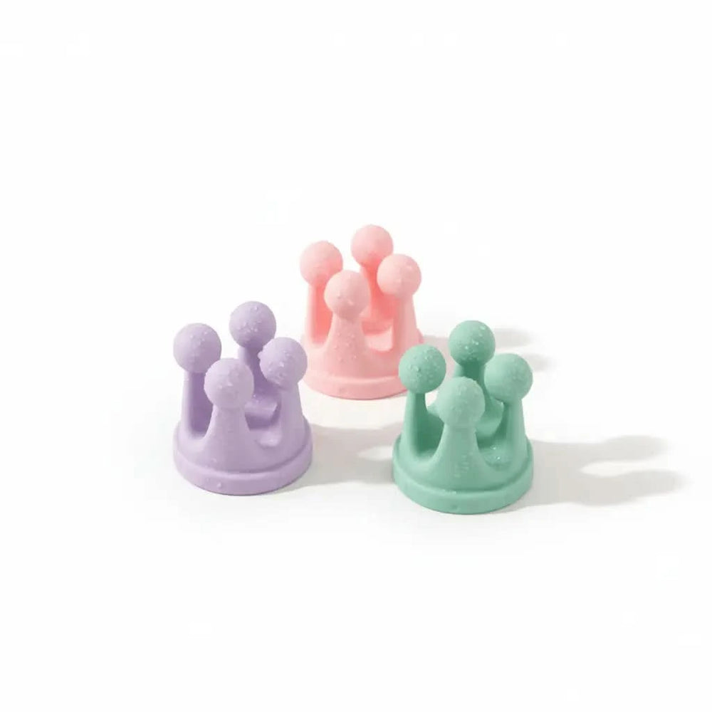 Three colorful crown-shaped objects on a white background