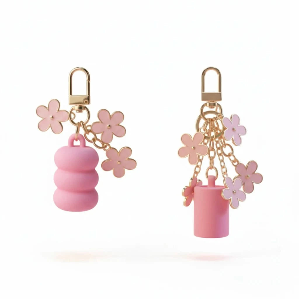 Pink keychains with floral designs on a white background