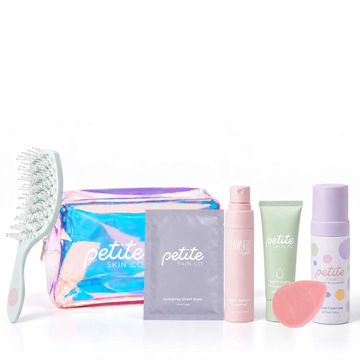 A skincare gift set from Petite Skin Co on a white background, featuring a holographic zippered pouch, a mint green hairbrush, a pink hydrating cream mask packet, a pink pump bottle, a light green tube, a white cleansing foam bottle with purple dots, and a pink silicone cleansing sponge.