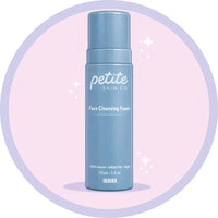 Blue bottle of 'petite skin co' Face Cleansing Foam on a light pink background