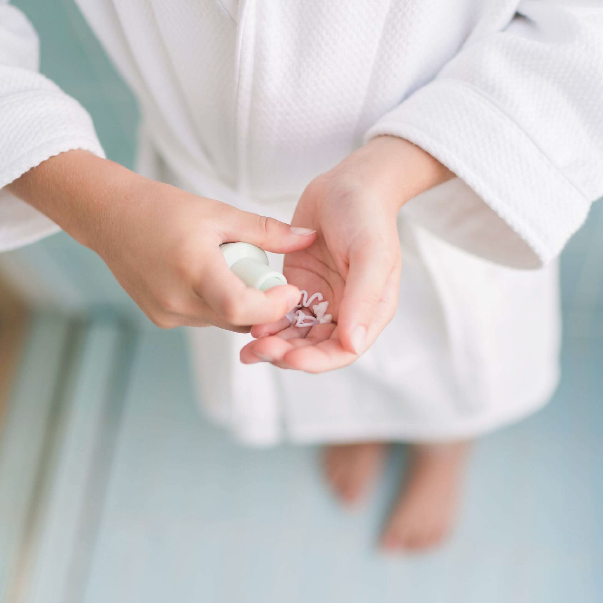 tween boy pumping petite skin co moisturiser into hands