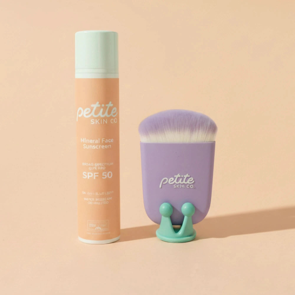 Petite Skin Co. sunscreen bottle and brush on a beige background