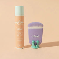 Petite Skin Co. sunscreen bottle and brush on a beige background